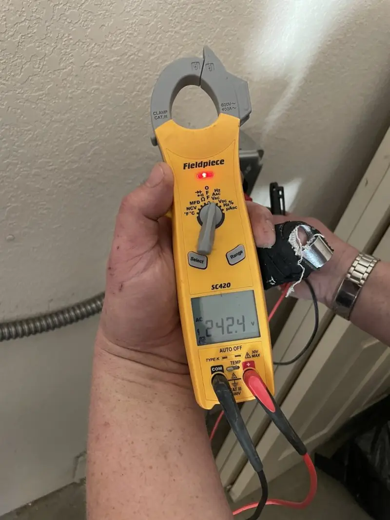 Voltage testing with clamp meter during Whole House Surge Protector in Brookfield